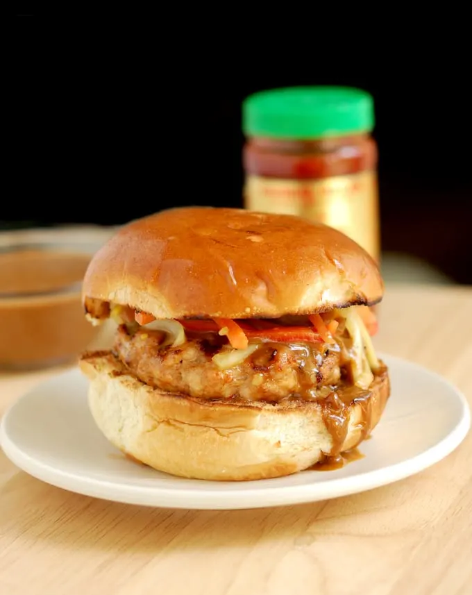 chicken satay burger with peanut sauce on a plate