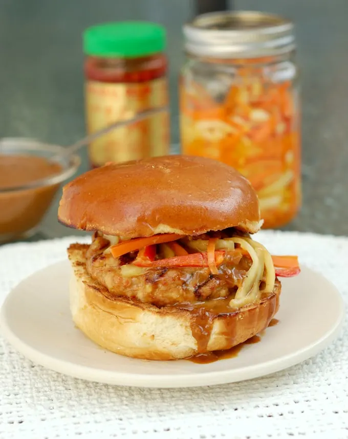 chicken satay burger with peanut sauce on a bun