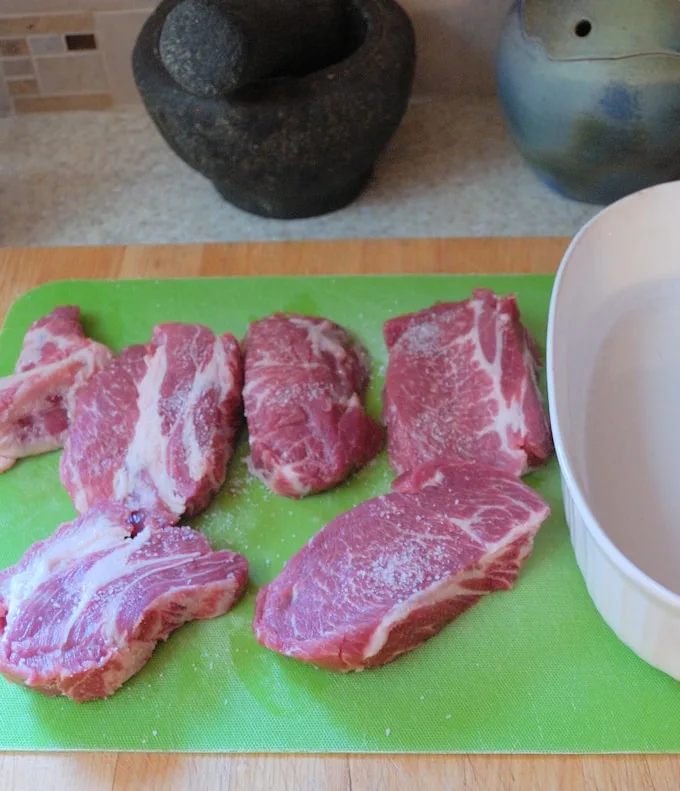 chunks of pork on a cutting board