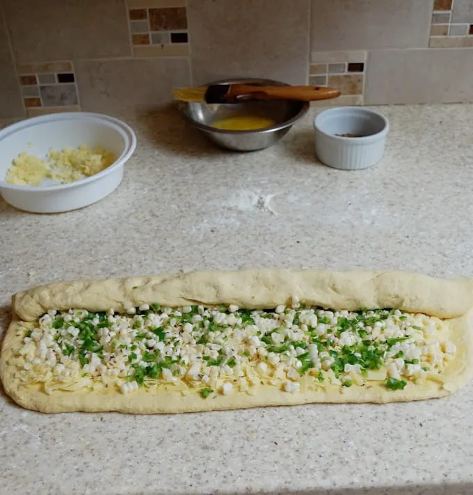 rolling the filling into sourdough cornbread