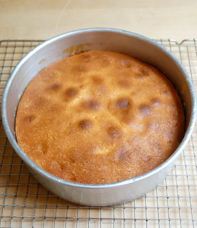 a baked peach cake in a pan. 
