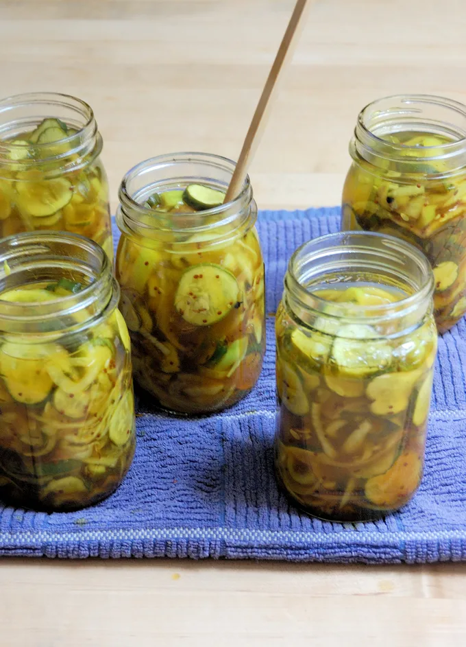 jars of bread and butter pickles being prepared for canning