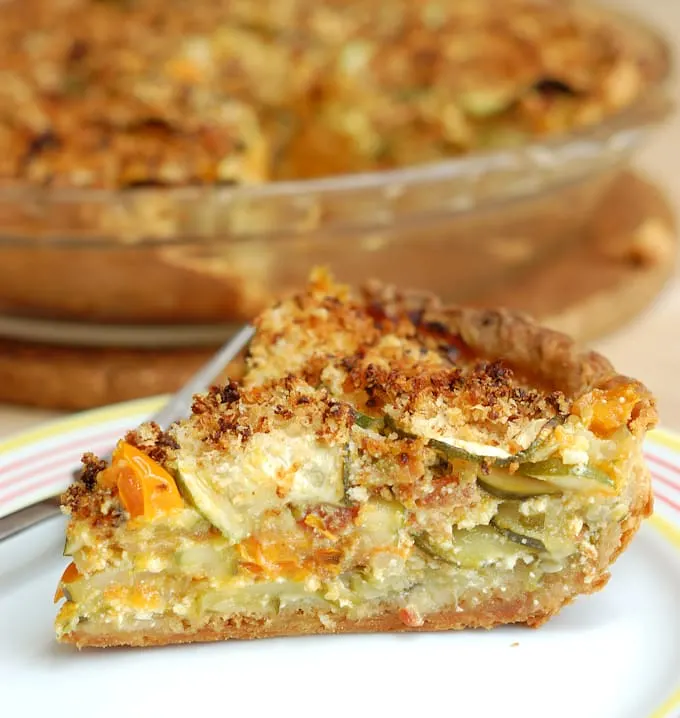 a slice of zucchini pie on a white plate.