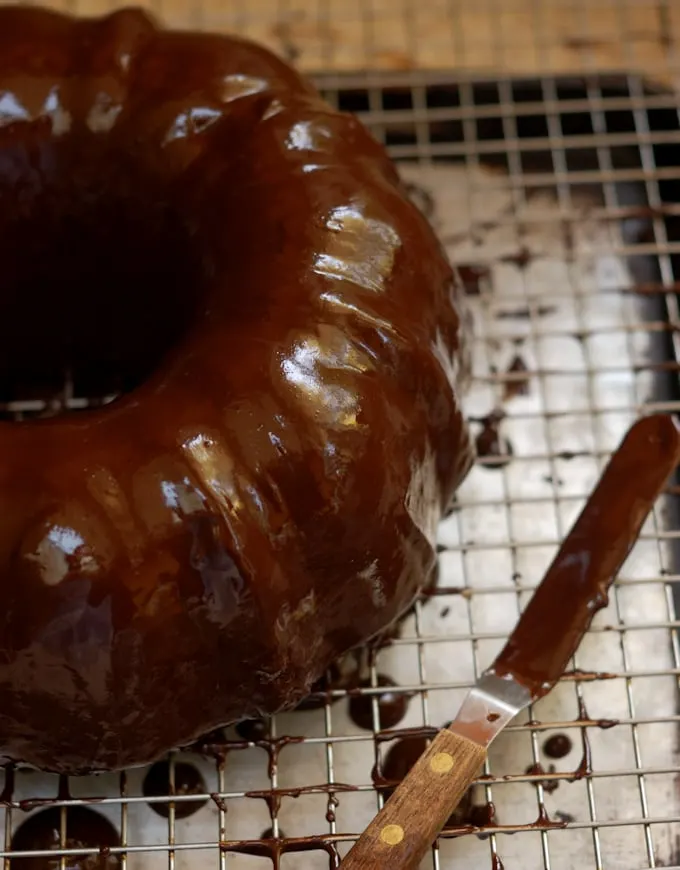 a chocolate glazed beet cake on a rack