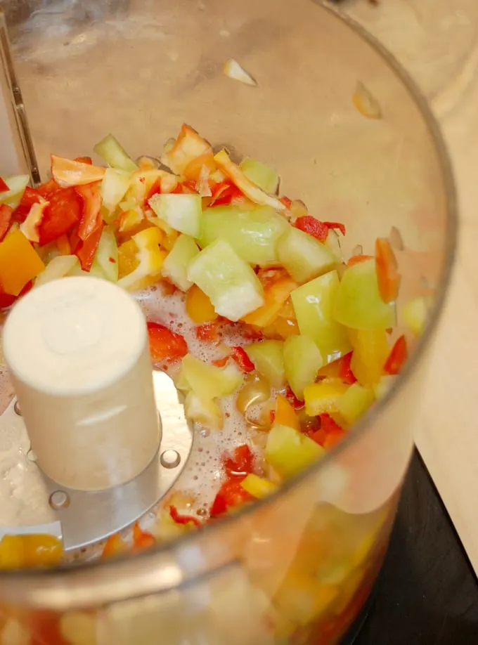 a food processor with chopped peppers