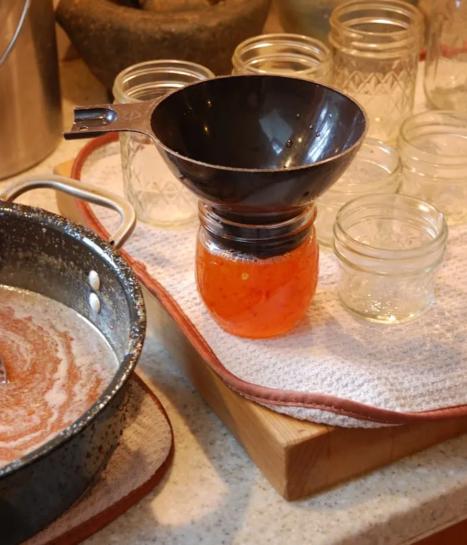 a canning jar with funnel.