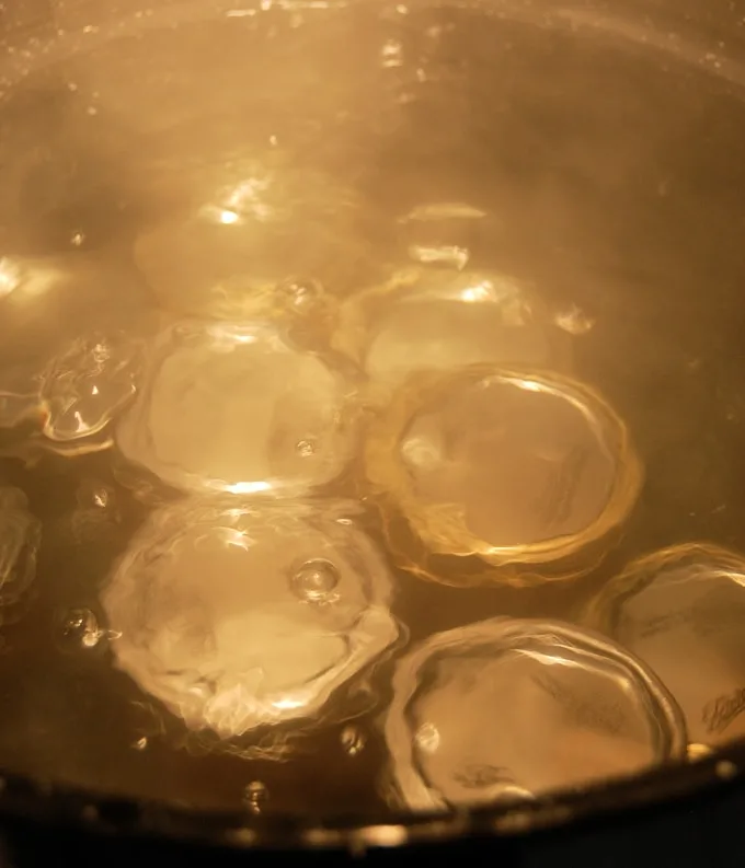 a water bath with jelly jars