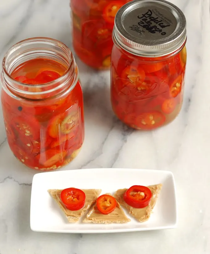 peanut butter and pickled jalapeno crackers on a plate.