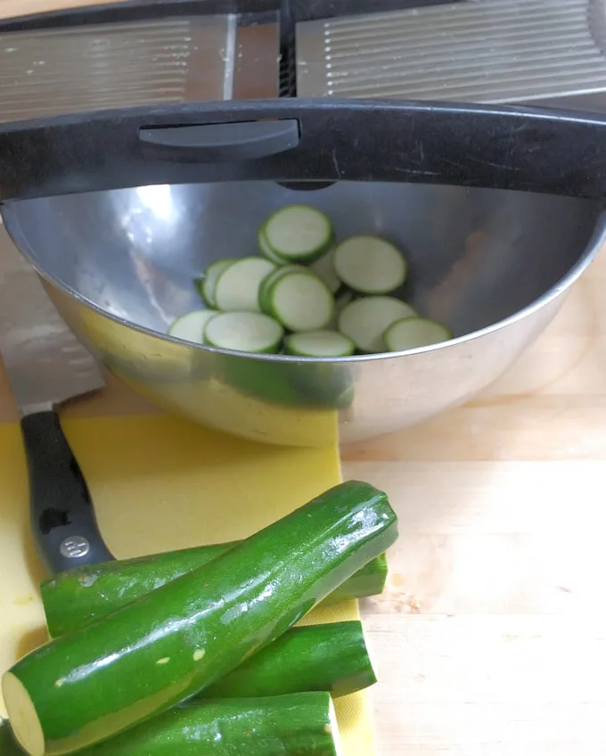 a mandoline slicing zucchini