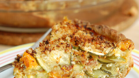 a slice of zucchini pie on a white plate.
