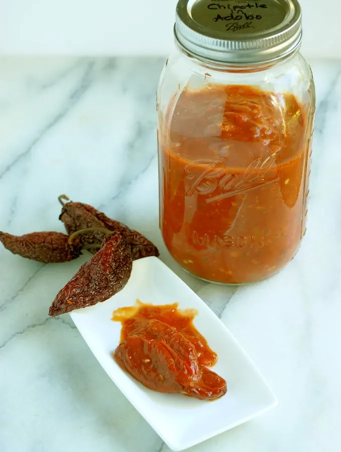 a plaste of chipotles in adobo and a jar of homemade sauce