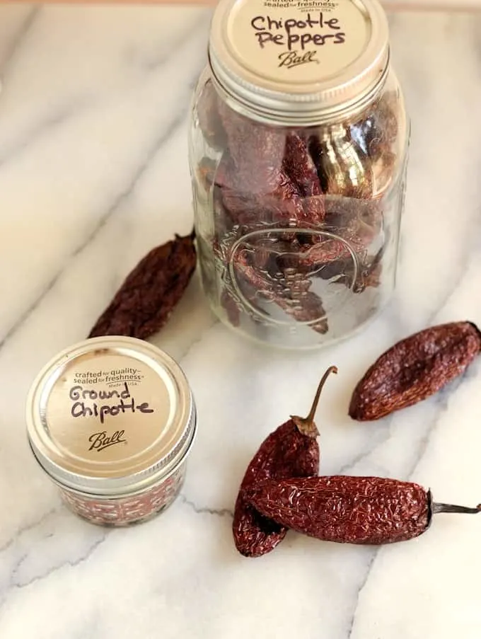 two jars of homemade chipotle peppers