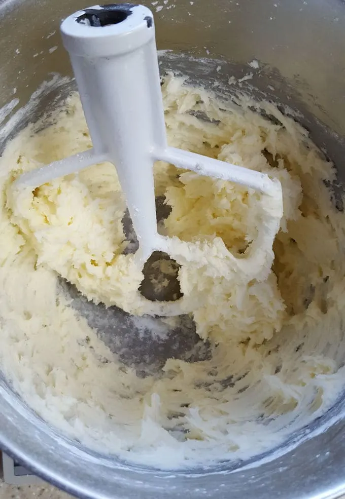 a mixing bowl with whipped butter and sugar