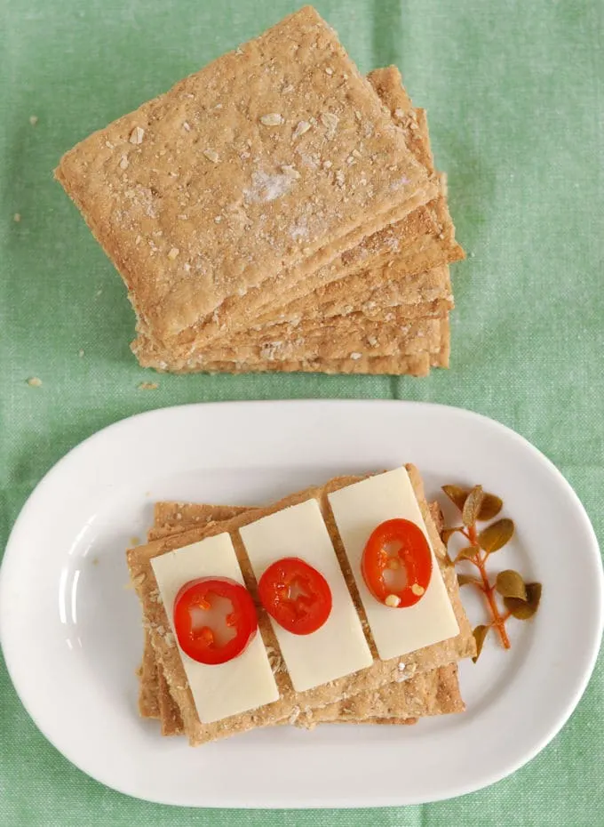 Oatmeal Knackebrod (oatmeal crispbread) topped with cheese and pickled jalapenos.