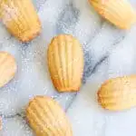 several brown butter almond madeleines on a marble surface