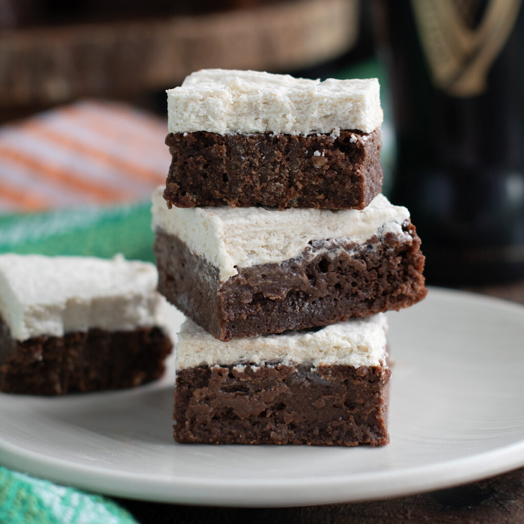 a stack of guinness brownies on a beige plate.