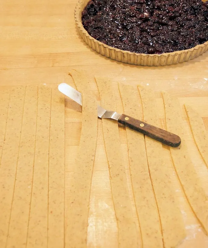showing how to cut strips and make lattice top for Cranberry Linzer Tart