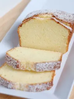 A sliced pound cake on a white tray