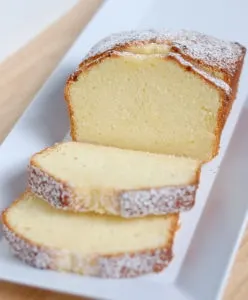 A sliced pound cake on a white tray