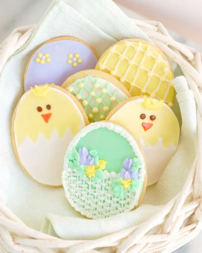 a basket of decorated sugar cookies for easter