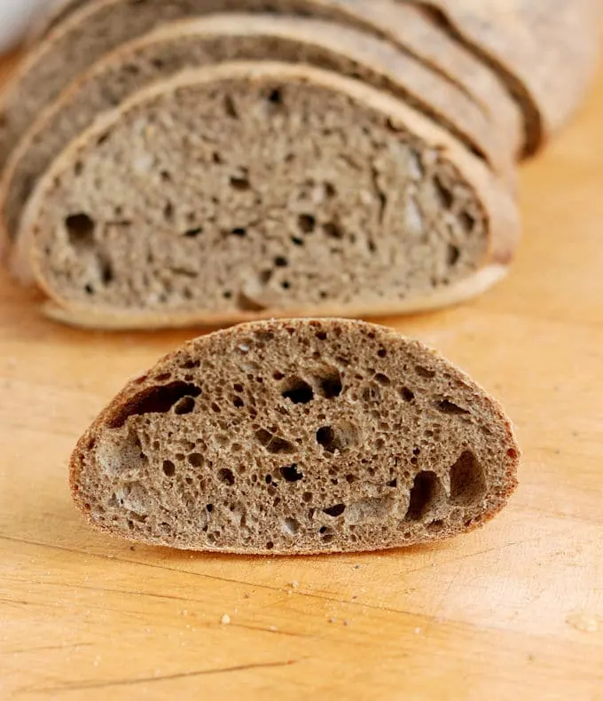 a slice of guinness buckwheat bread made with sourdough starter