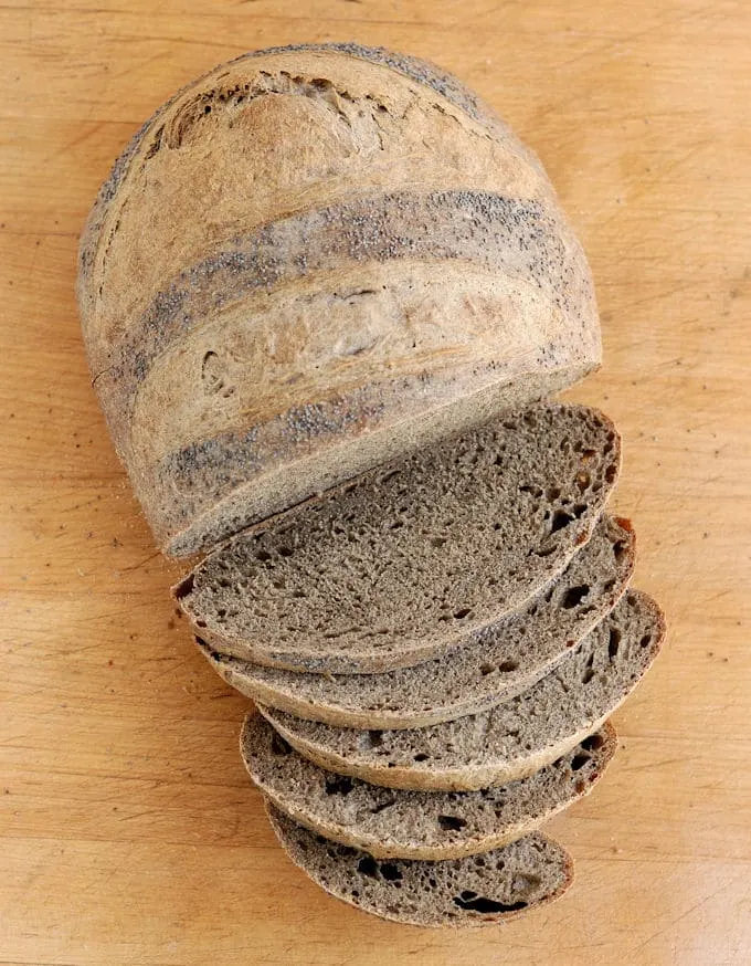 guinness buckwheat bread, sliced on a cutting board.