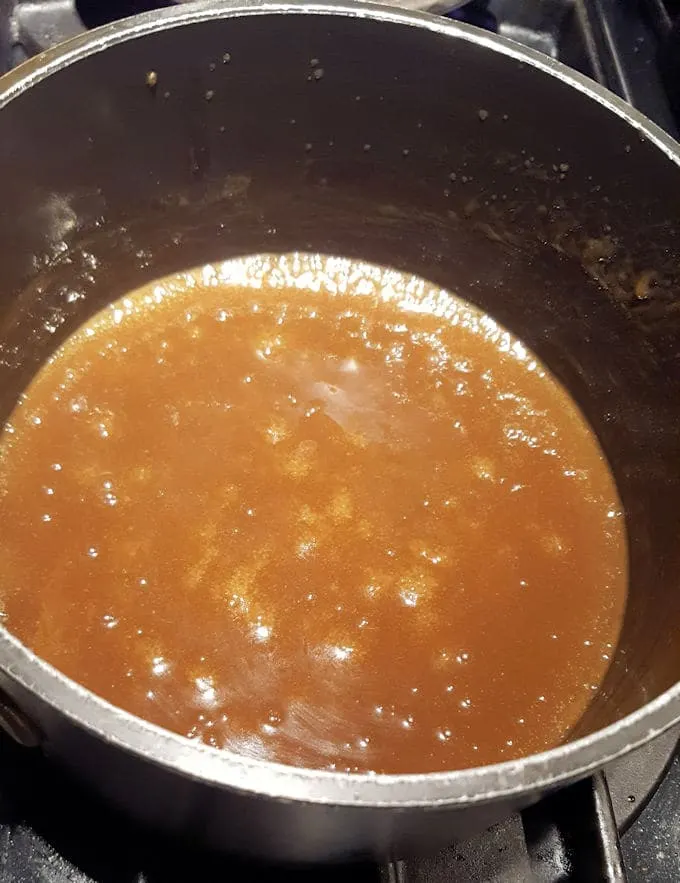 a pot of smooth butterscotch sauce