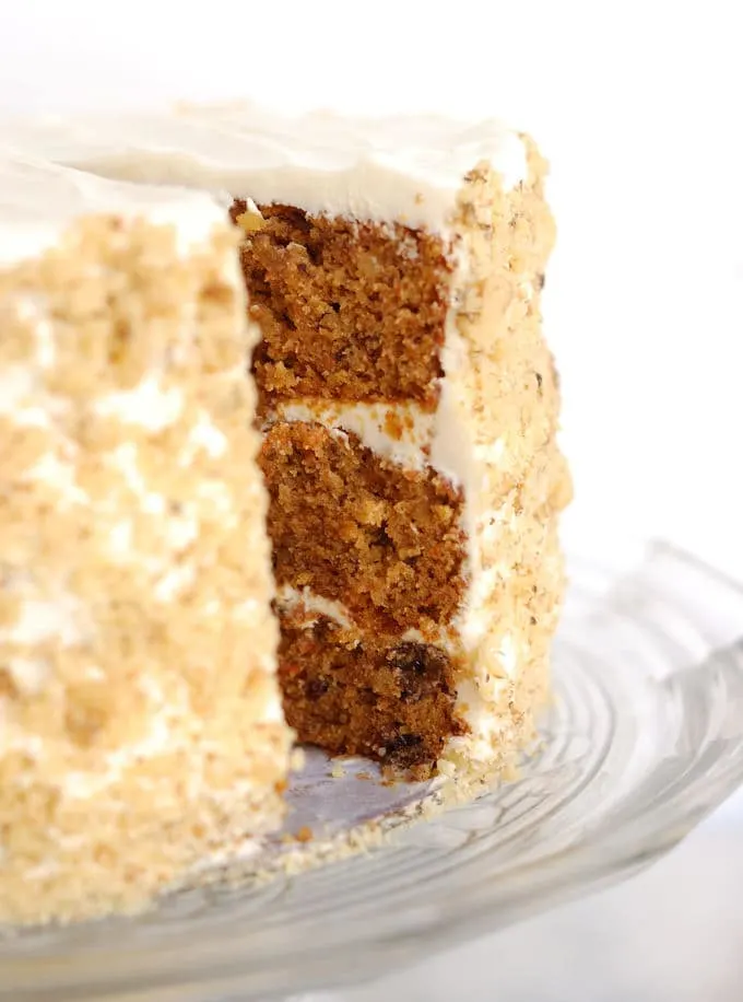 a sliced carrot cake on a cake stand