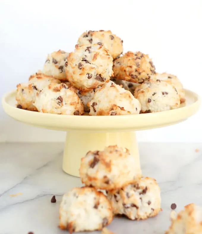 a pile of coconut macaroons on a cake plate