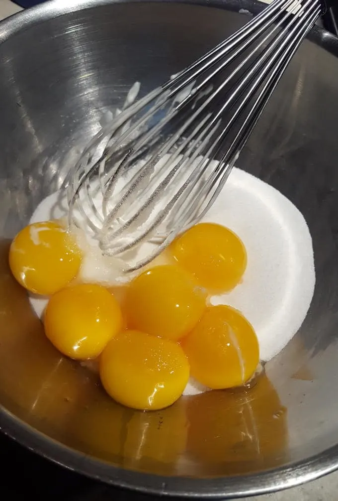 egg yolks and sugar in a bowl.