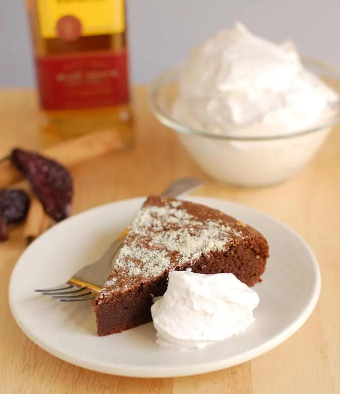 a slice of flourless mexican hot chocolate cake with cream