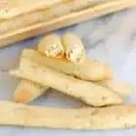 herbed goat cheese stuffed breadsticks on a marble table