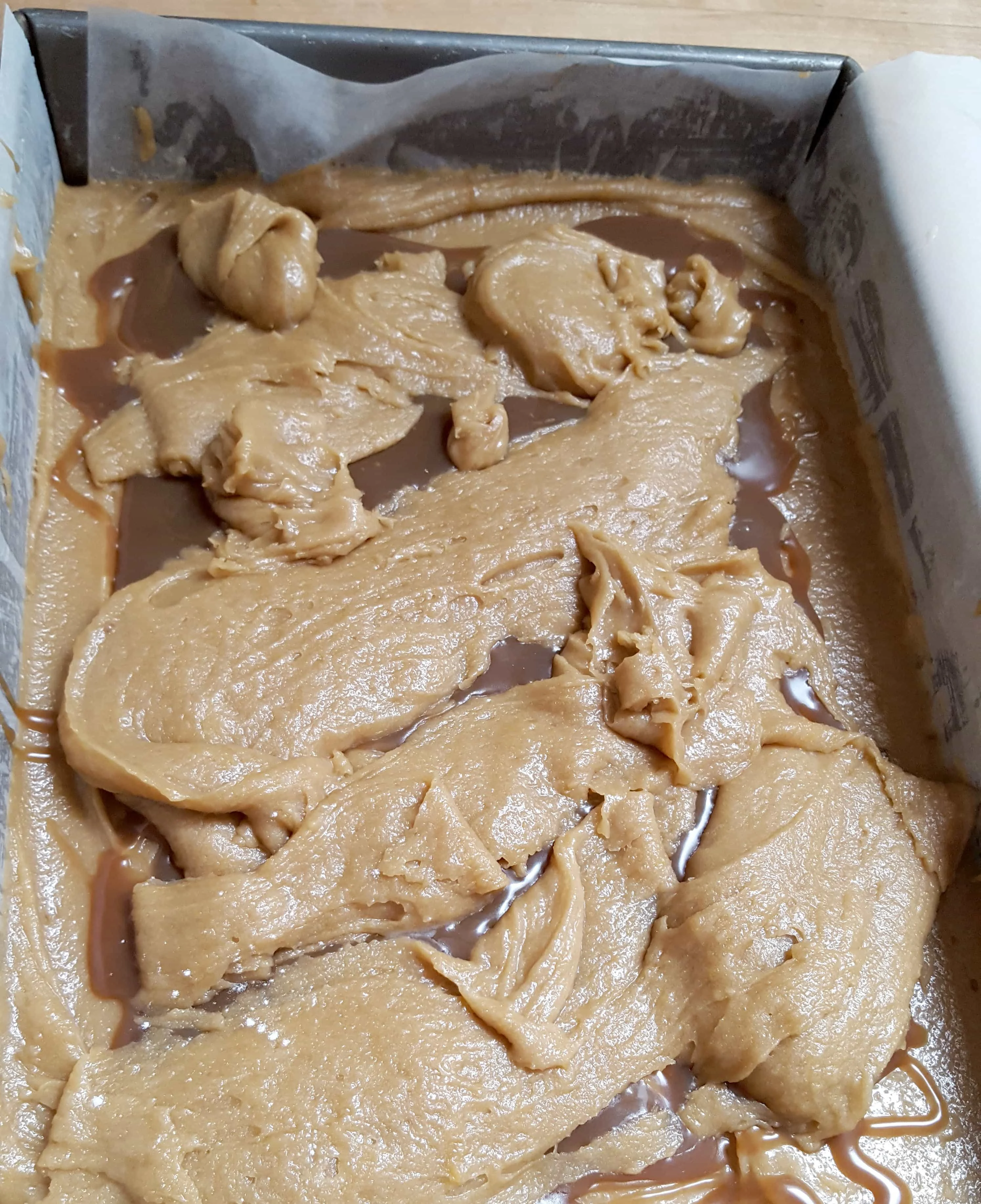 butterscotch ripple blondie batter in a pan