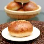 a milk & honey whole wheat burger bun on a plate