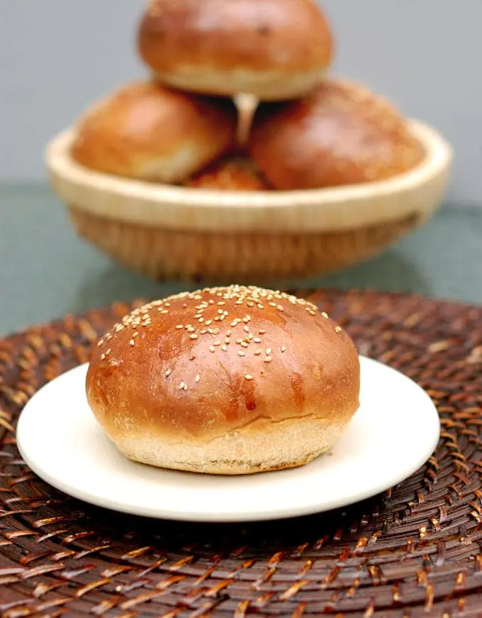 a plate with a milk & honey whole wheat burger bun