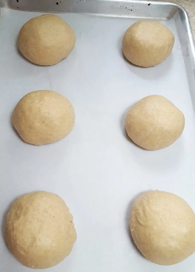 a tray of burger buns ready for the oven