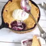 a Blueberry Cornbread Cobbler in a cast iron skillet