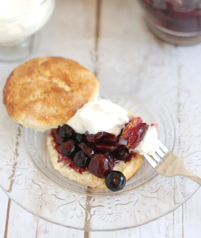 a cherry blueberry shortcake on a glass plate