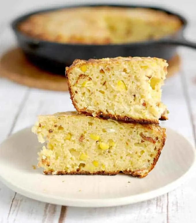 2 slices of smoked cornbread with bacon on a plate