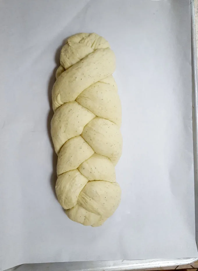 a braided loaf of bread on a sheet pan