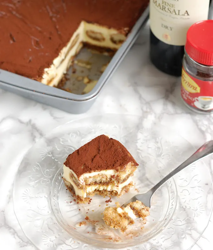 a half eaten portion of frozen tiramisu ice cream cake