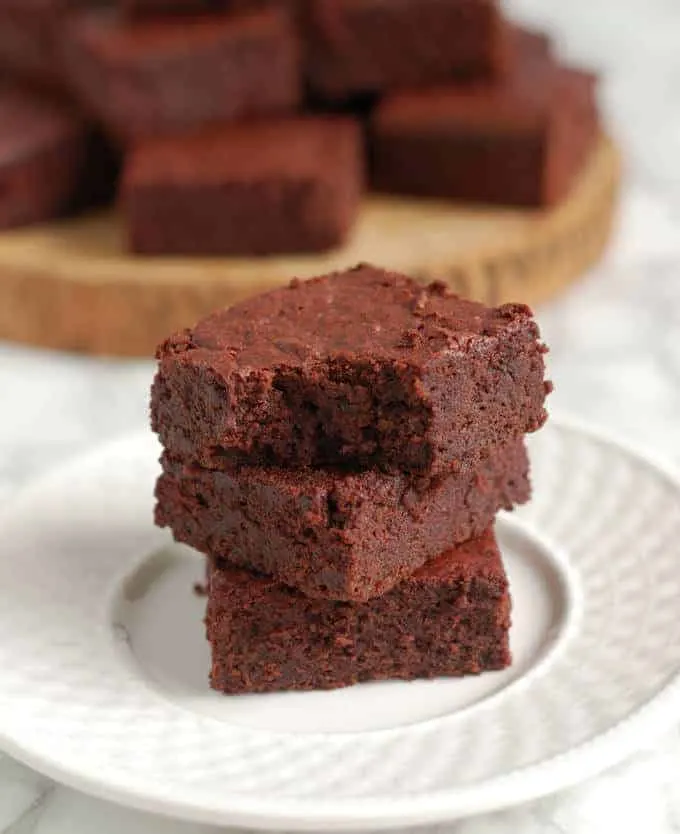 a stack of roasted beet brownies, one with a bite