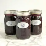 three jars of homemade Concord Grape Jam
