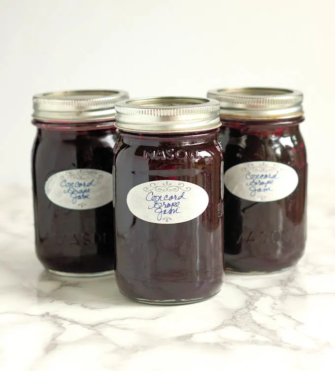 three jars of homemade Concord Grape Jam