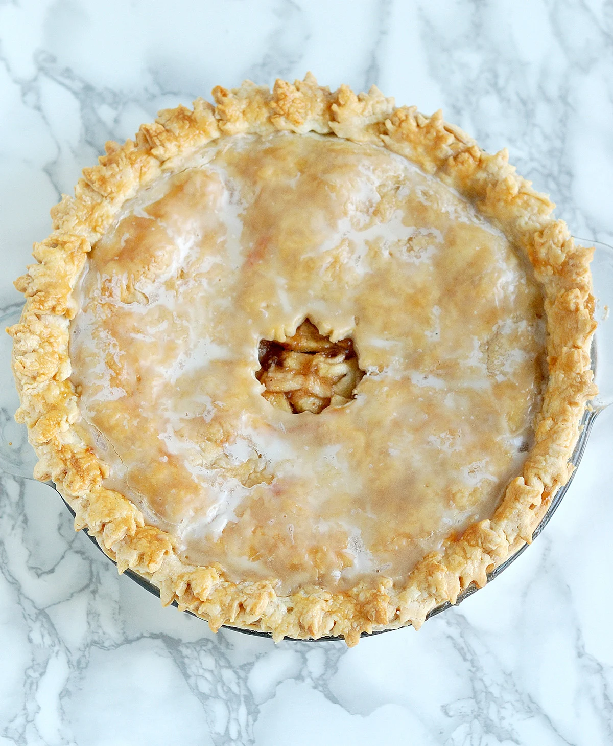 an apple pie on a white surface.