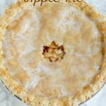 a maple glazed apple pie on a marble table.