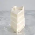 a slice of velvety soft white cake