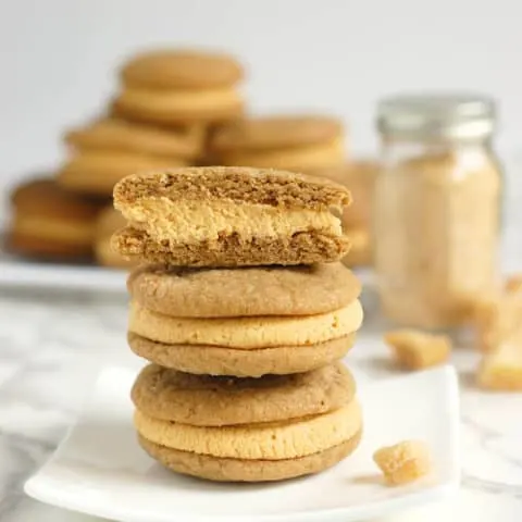 a stack of Ginger Sandwich Cookies with pumpkin ganache
