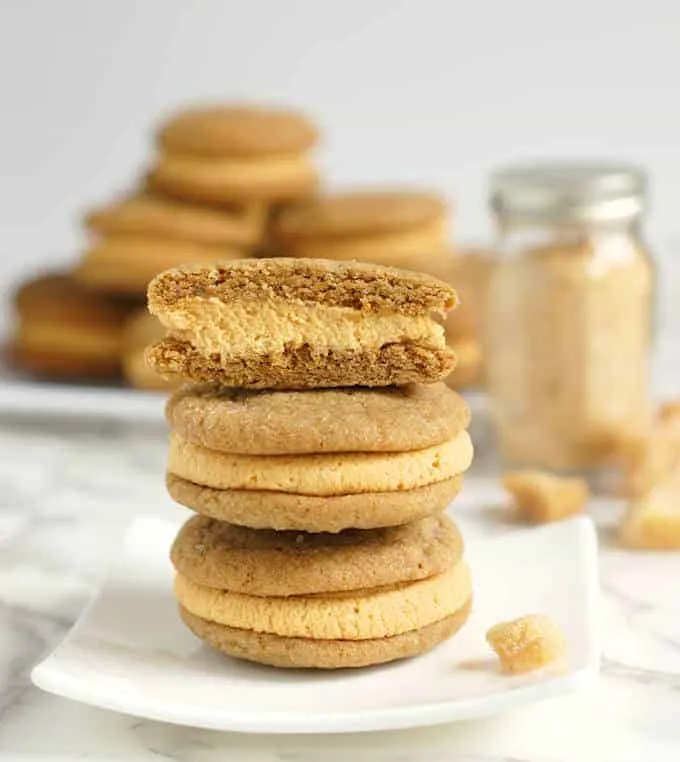 a stack of Ginger Sandwich Cookies with pumpkin ganache