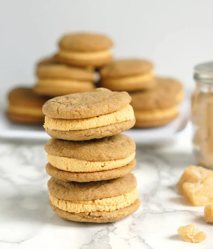 a stack of ginger sandwich cookies with pumpkin ganache filling